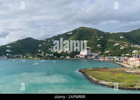 Road Town, British Virgin Islands - December 16, 2018: Coastline along a Road Town in Tortola, British Virgin Islands. The wooded hilltops above Road Stock Photo