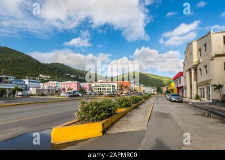 Road Town, British Virgin Islands - December 16, 2018: Street view of Road Town at day with parked cars near tourist shops and flowerbeds in front of Stock Photo