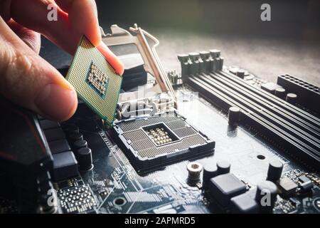 Electronic engineer of computer technology. Maintenance computer cpu hardware upgrade of motherboard component. Pc repair, technician and industry Stock Photo