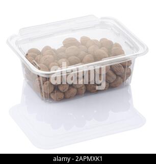 pecan nuts in a transparent plastic food box isolated on a white background with clipping path Stock Photo