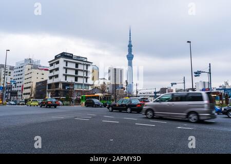 Tokyo, JAPAN - March 30, 2019: car is passing through the intersection with Tokyo Skytree backgruond in Asakusa, Tokyo, Japan. Stock Photo