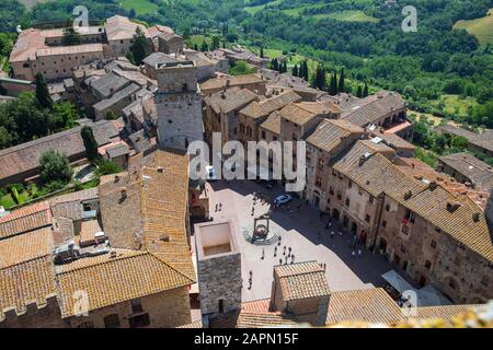 View of Piazza della Cisterna, Torre del Diavolo & Ardinghelli towers in San Gimignano, Italy. Stock Photo