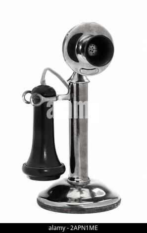 Antique brass candlestick telephone made around 1910 in black and white. Stock Photo