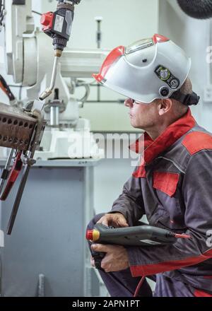 Engineer check and control welding robotics automatic arms machine in intelligent factory automotive industrial with monitoring system software. Digit Stock Photo