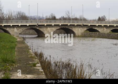 Panoramic shot of an old stone arc bridge over Otuca river in Gracac, Croatia Stock Photo
