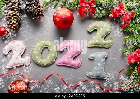 Stitched polkadot fabric digits of 2, 0, 1, 20, 2021  with Christmas decorationsaside flat lay on wooden background Stock Photo