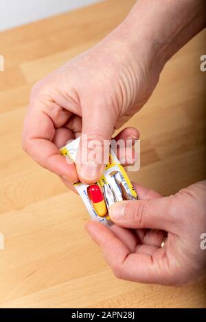 Medicine : capsules in the hand of a woman, woman taking medicine Stock Photo