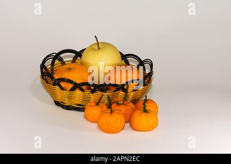 Basket and fresh fruits isolated on white background Stock Photo