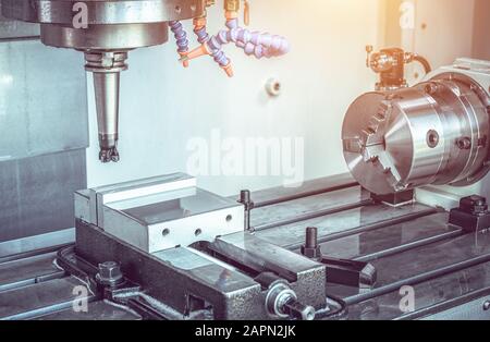 High precision CNC machining center working, operator machining automotive sample part process in industrial factory Stock Photo