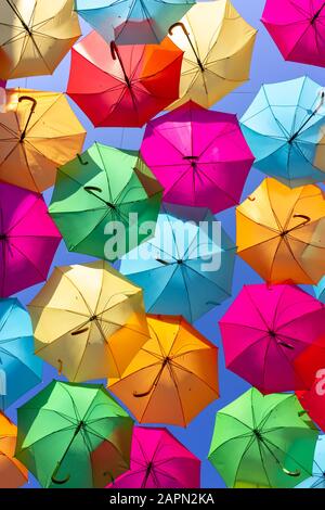 A shot from below a beautiful display of colorful hanging umbrellas Stock Photo