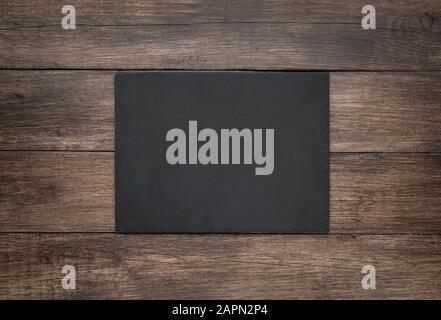 Blank slate board on wooden background Stock Photo