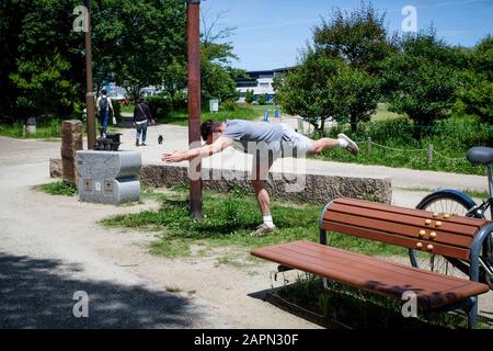A man exercising by himself in a park in Kyoto, Japan. Stock Photo