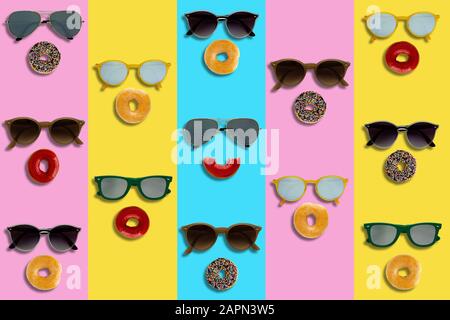 Sunglasses and Donuts set as the face on colorful background for minimal and summer background concept. Stock Photo