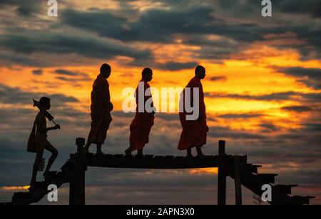 Buddhist monks on everyday morning traditional alms giving in Thailand. Stock Photo