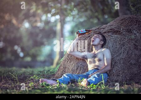 alcoholism, alcohol addiction and people concept. male alcoholic with wine bottle. Alcohol abuse. drunk man. concept of alcoholism. brutal man suffer Stock Photo