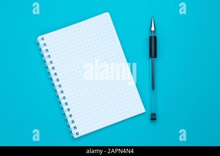 Blank notebook and pen on blue background. Copy space. Education concept. Stock Photo