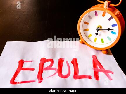 Overhead shot of the word "EBULA" written on a piece of white paper Stock Photo