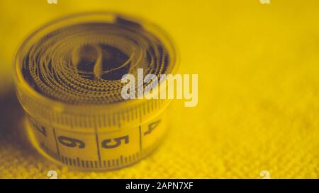Yellow measuring tape in box on the table Stock Photo