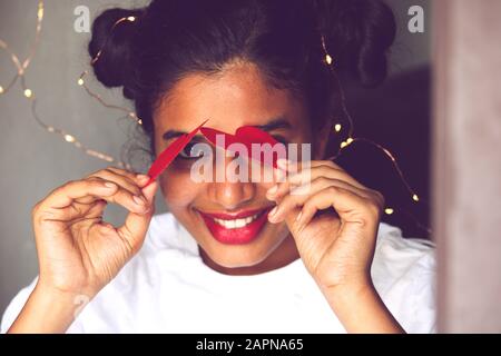 Cute girl with hearts on Valentine’s Day Stock Photo