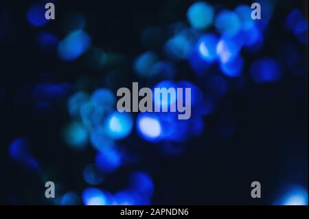 Blue lights and sparkles in defocus. Abstract stylish background. Stock Photo