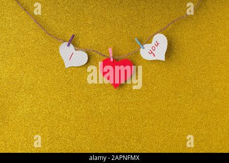 Red paper hearts hanging on the rope in valentine day concept. Stock Photo
