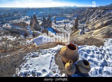 Cappadocia. Turkey. View from mountain on the unusual winter landscape with cliffs at morning time. Landscape of Cappadocia with traditional jugs Stock Photo