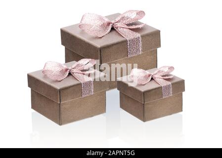Three brown gift boxes isolate on a white background, close-up, reflection. Stock Photo