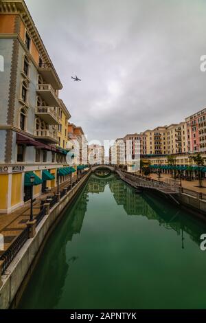 DOHA, QATAR - January 10 2020. Canal view in Venice-like Qanat Quartier of the Pearl precinct of Doha, Qatar, with multi-color residential buildings, Stock Photo