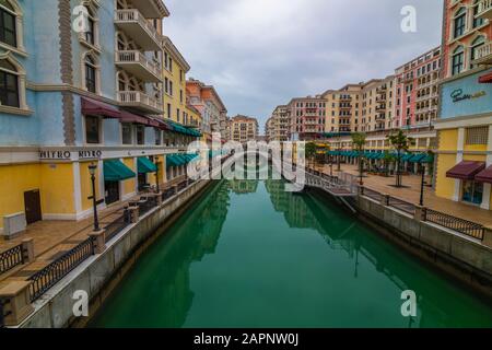 DOHA, QATAR - January 10 2020. Canal view in Venice-like Qanat Quartier of the Pearl precinct of Doha, Qatar, with multi-color residential buildings, Stock Photo