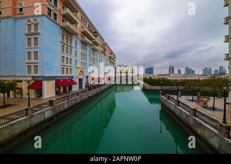 DOHA, QATAR - January 10 2020. Canal view in Venice-like Qanat Quartier of the Pearl precinct of Doha, Qatar, with multi-color residential buildings, Stock Photo