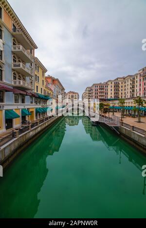 DOHA, QATAR - January 10 2020. Canal view in Venice-like Qanat Quartier of the Pearl precinct of Doha, Qatar, with multi-color residential buildings, Stock Photo