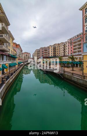 DOHA, QATAR - January 10 2020. Canal view in Venice-like Qanat Quartier of the Pearl precinct of Doha, Qatar, with multi-color residential buildings, Stock Photo