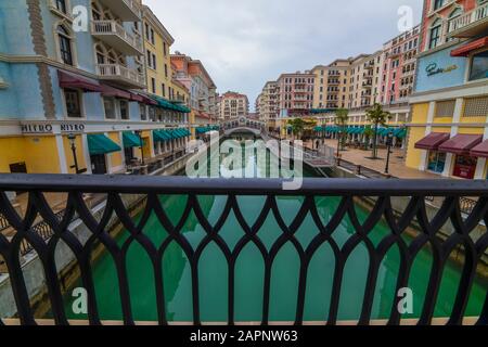 DOHA, QATAR - January 10 2020. Canal view in Venice-like Qanat Quartier of the Pearl precinct of Doha, Qatar, with multi-color residential buildings, Stock Photo