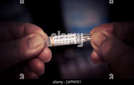 KYIV, UKRAINE-DECEMBER, 2019: Injection of Amoxicillin. Ampoule in a Old Hands. Healthcare Pharmacy Treatment Concept. Close. Macro. Stock Photo