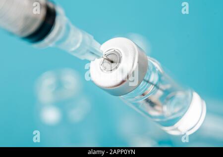 Vaccine vial dose with needle syringe, medical concept vaccination in laboratory background. Stock Photo