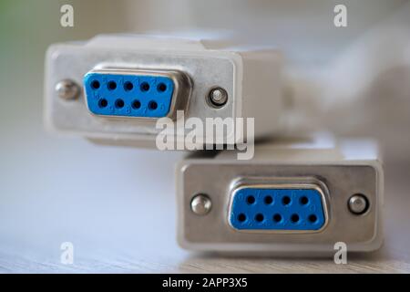 Close-up of a RS-232 serial port. Female to female extension cord on a wooden table. Stock Photo