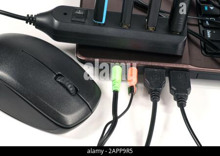Fully used USB hub (each device has a device plugged into it) connected to the laptop. Stock Photo