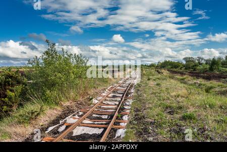 A railway track used for machine access to an industrial Bord na Mona cut away bog used for peat extraction near Cloghan, County Offaly, Ireland Stock Photo