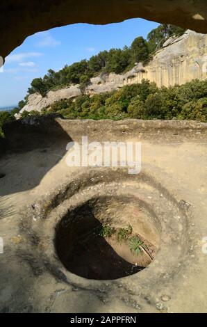 Rock-Cut Storage Jars or Silos in the Abandoned Troglodyte Village of the Grottes de Calès at Lamanon Alpilles Provence France Stock Photo