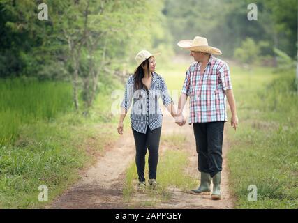 Happy senior couple taking a walk in summer countryside Stock Photo