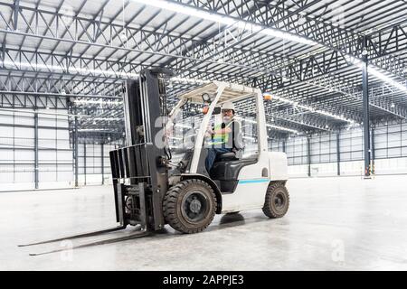 Warehouse worker driver in uniform at storage warehouse Stock Photo