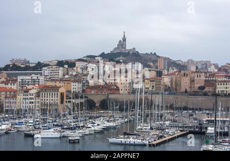 Aerial panoramic view on basilica of Notre Dame de la Garde and old port in Marseille, France at winter time Stock Photo