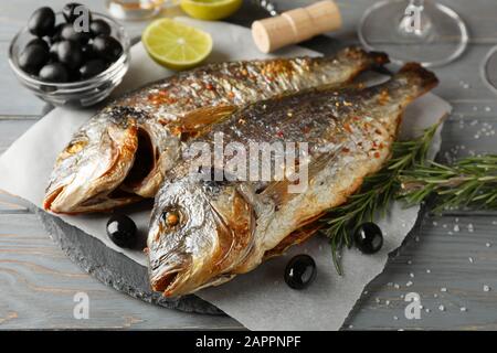 Grilled Dorado on garnished wooden background, close up Stock Photo
