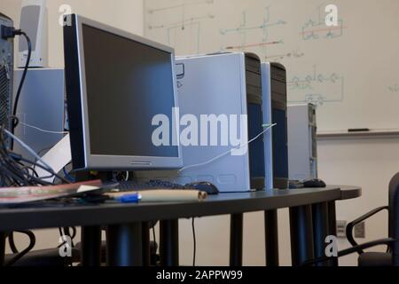 Computer monitors and hard drives sitting on a table Stock Photo