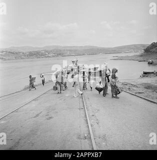 Zaire (formerly Belgian Congo)  Group of people by a river; at berth ship Date: 24 October 1973 Location: Congo, Zaire Keywords: Rivers, Shipping Stock Photo