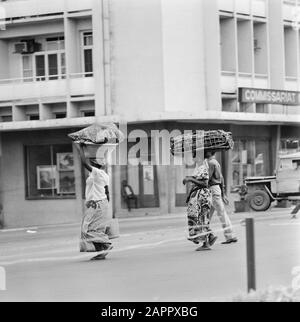 Zaire (formerly Belgian Congo)  Street statue in Kinshasa: women wear baskets with food on their heads Date: October 24, 1973 Location: Congo, Kinshasa, Zaire Keywords: cityscapes Stock Photo