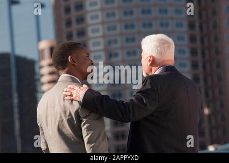Older businessman mentoring a younger businessman Stock Photo