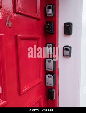 Airbnb key boxes on the door pillar of a property in Edinburgh, Scotland, UK Stock Photo