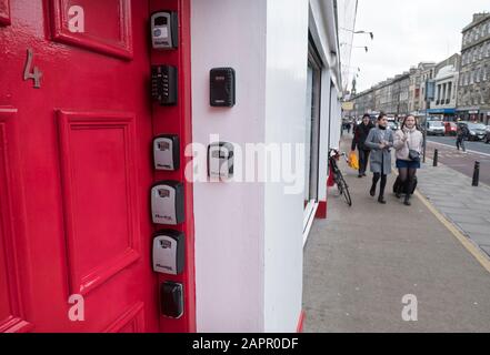 Airbnb key boxes on the door pillar of a property in Edinburgh, Scotland, UK Stock Photo