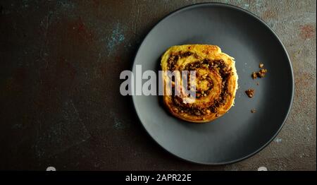 Concept of bavarian food. Homemade sweet yeast dough brioches filled with chopped nuts. Snail buns with nuts, Nussschnecken Stock Photo
